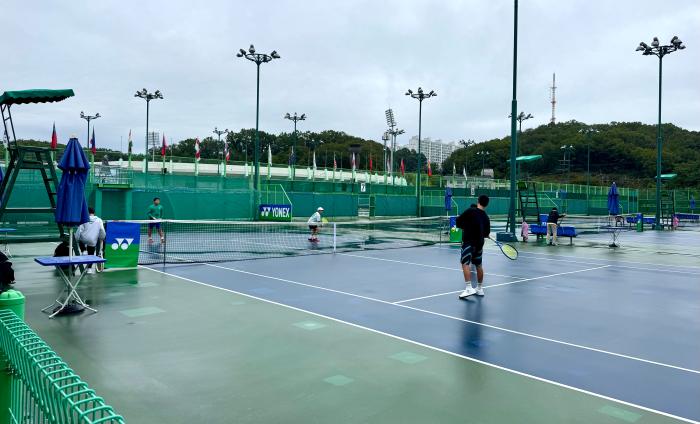 비가 그치자 몸이 근질근질 했던 선수들이 채 마르지도 않은 코트에서 가볍게 몸을 풀고 있다